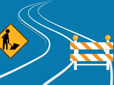 A road with construction signs.