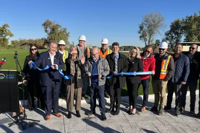 Warden Hilda MacDonald cuts a blue ribbon with colleagues at the roundabout at County Road 42 and County Road 43