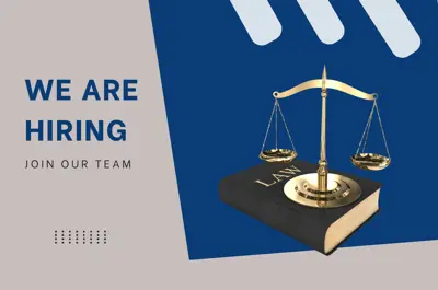We are hiring. Join our team.  A law book and scales of justice.
