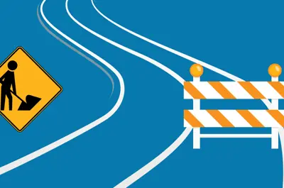A road with construction signs.